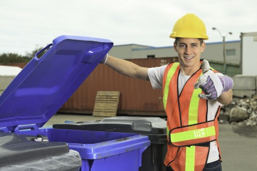 High-visibility crew loading bulky commercial waste safely